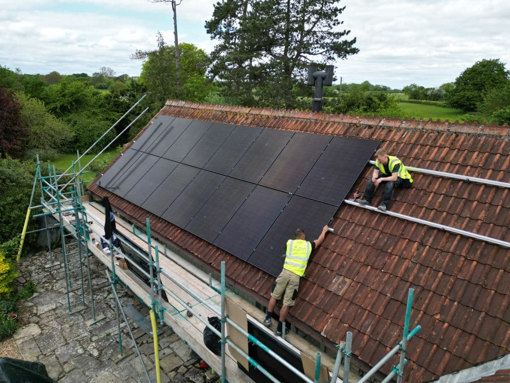 solar panel installation team working residential roof