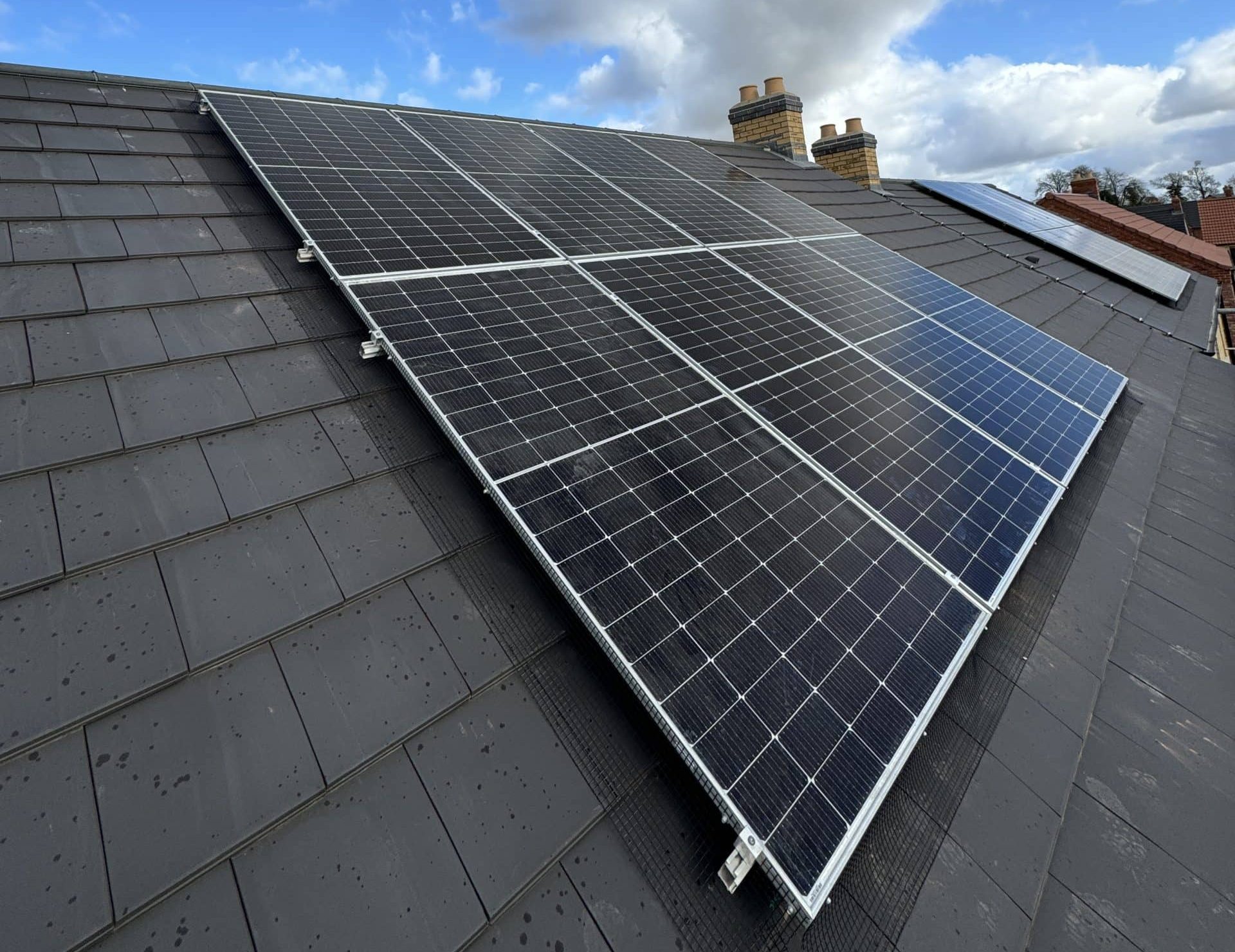 Professional solar panel installation on UK residential property showing panel layout and mounting system