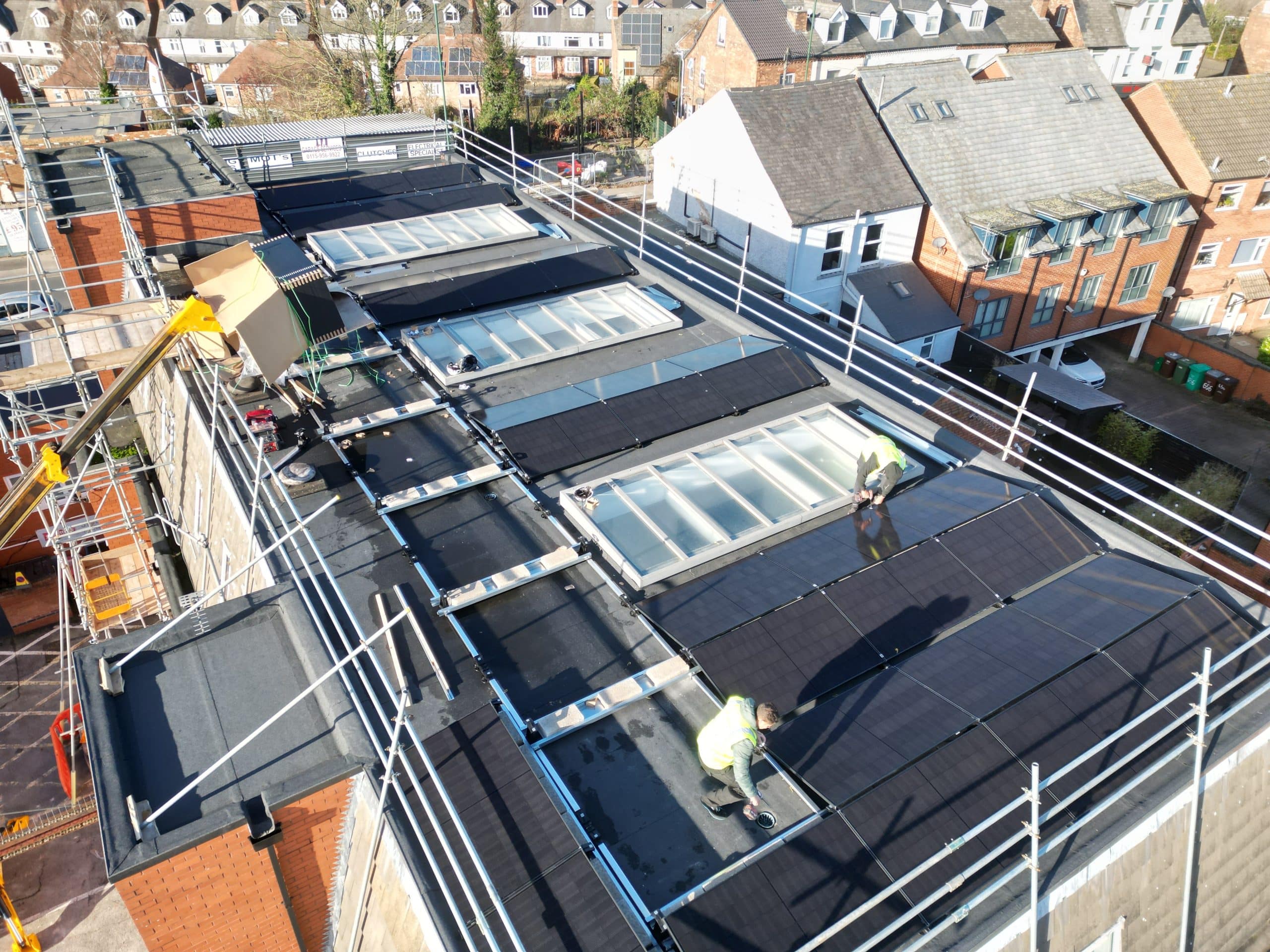 JA Solar 500W all-black panels being installed on Esdec flat roof mounting system at Johns of Nottingham
