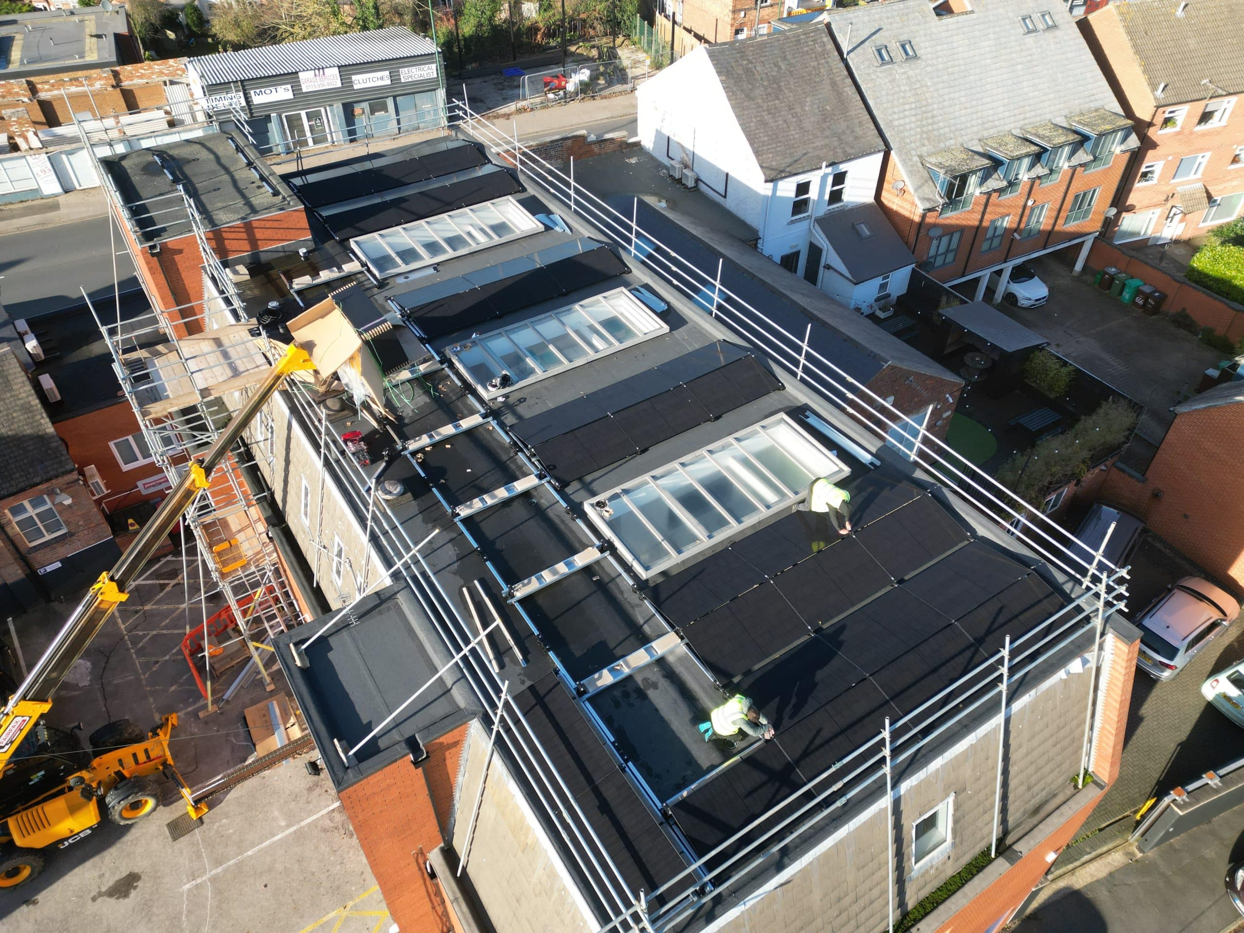 35kW solar panel installation progress with 18-metre telehandler on site at Johns of Nottingham commercial premises