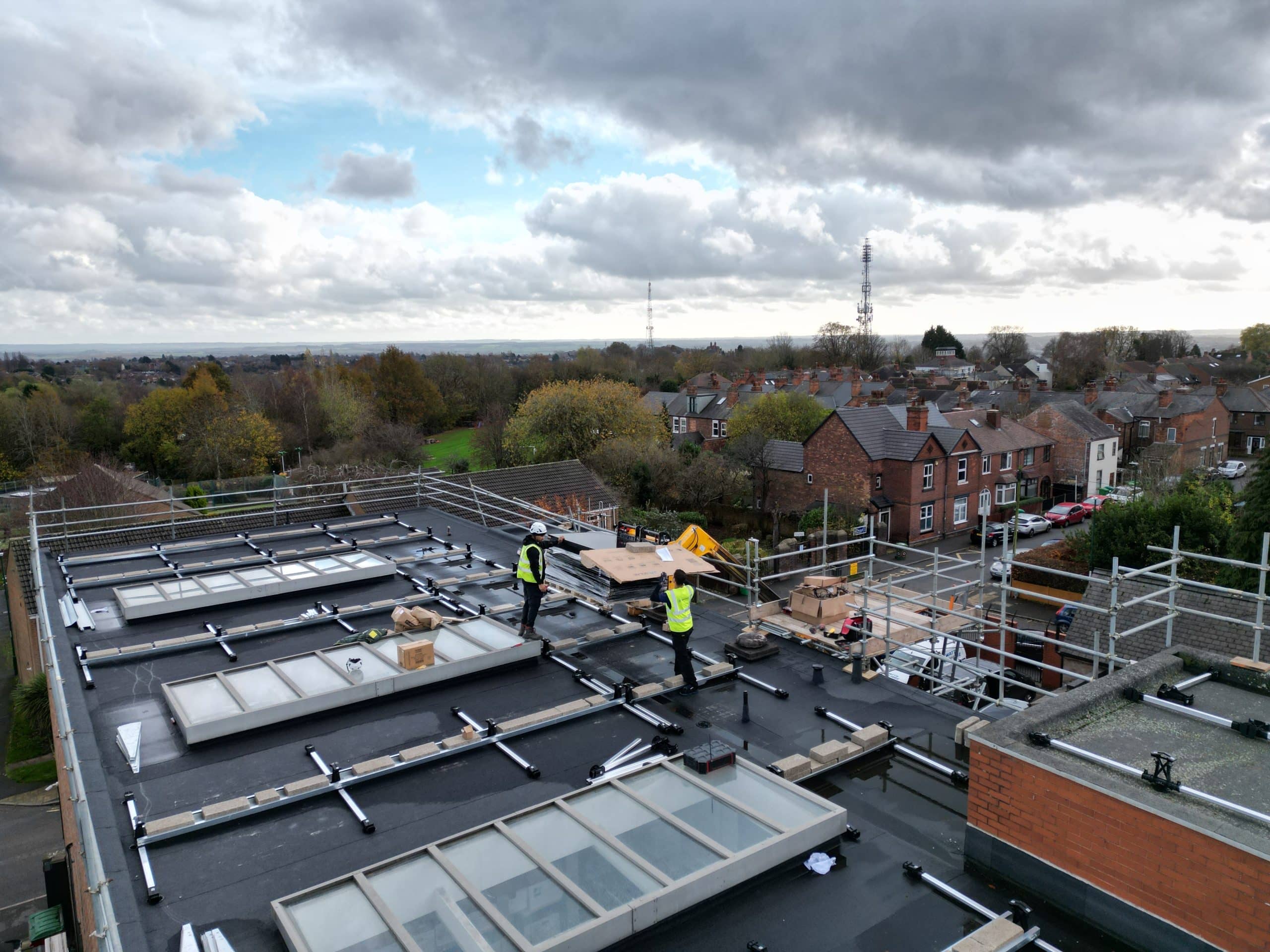 Esdec flat roof mounting rails and ballast layout during early installation phase at Johns of Nottingham