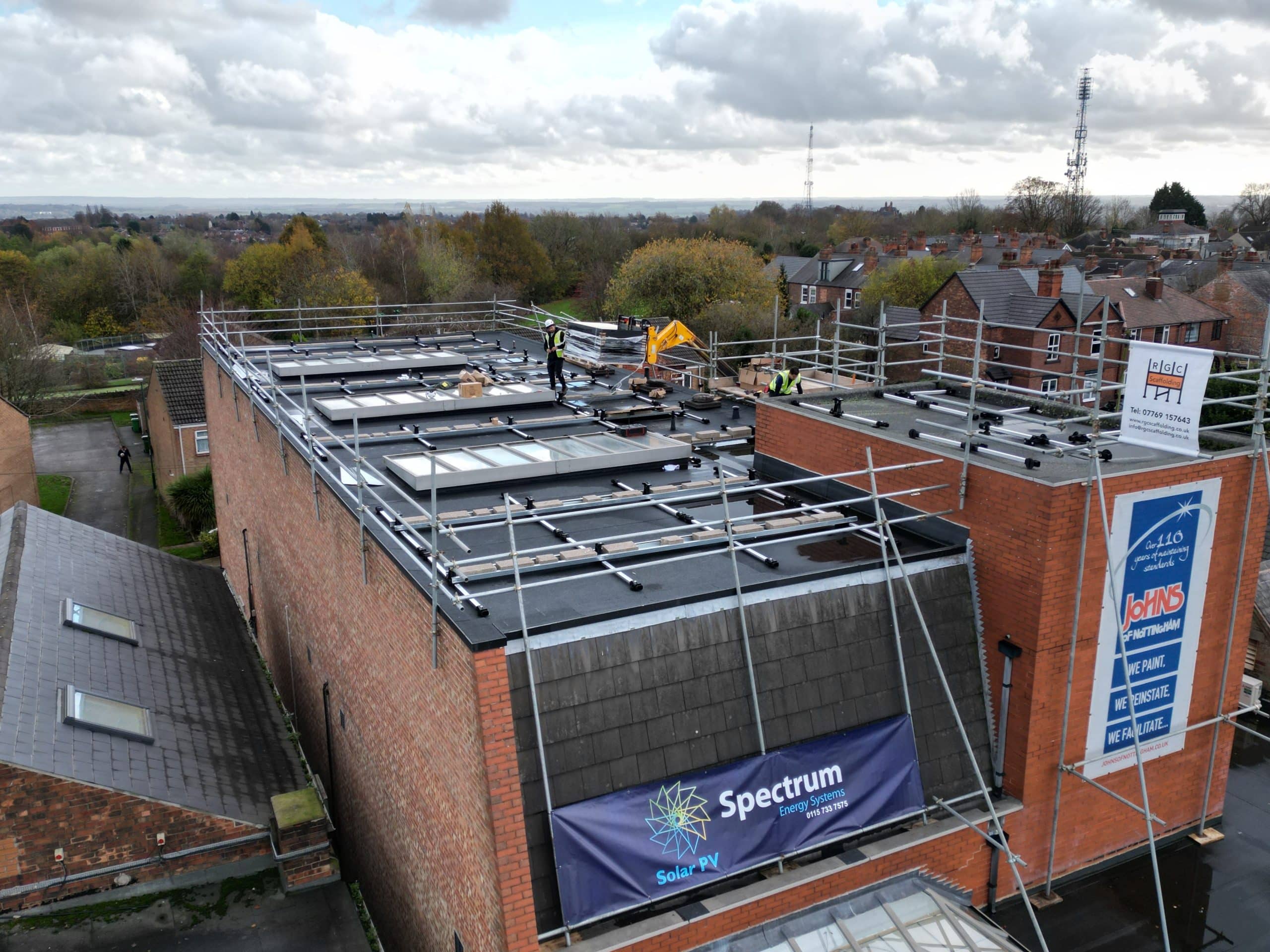 Esdec flat roof mounting rails and ballast layout during commercial solar installation at Johns of Nottingham three-storey building