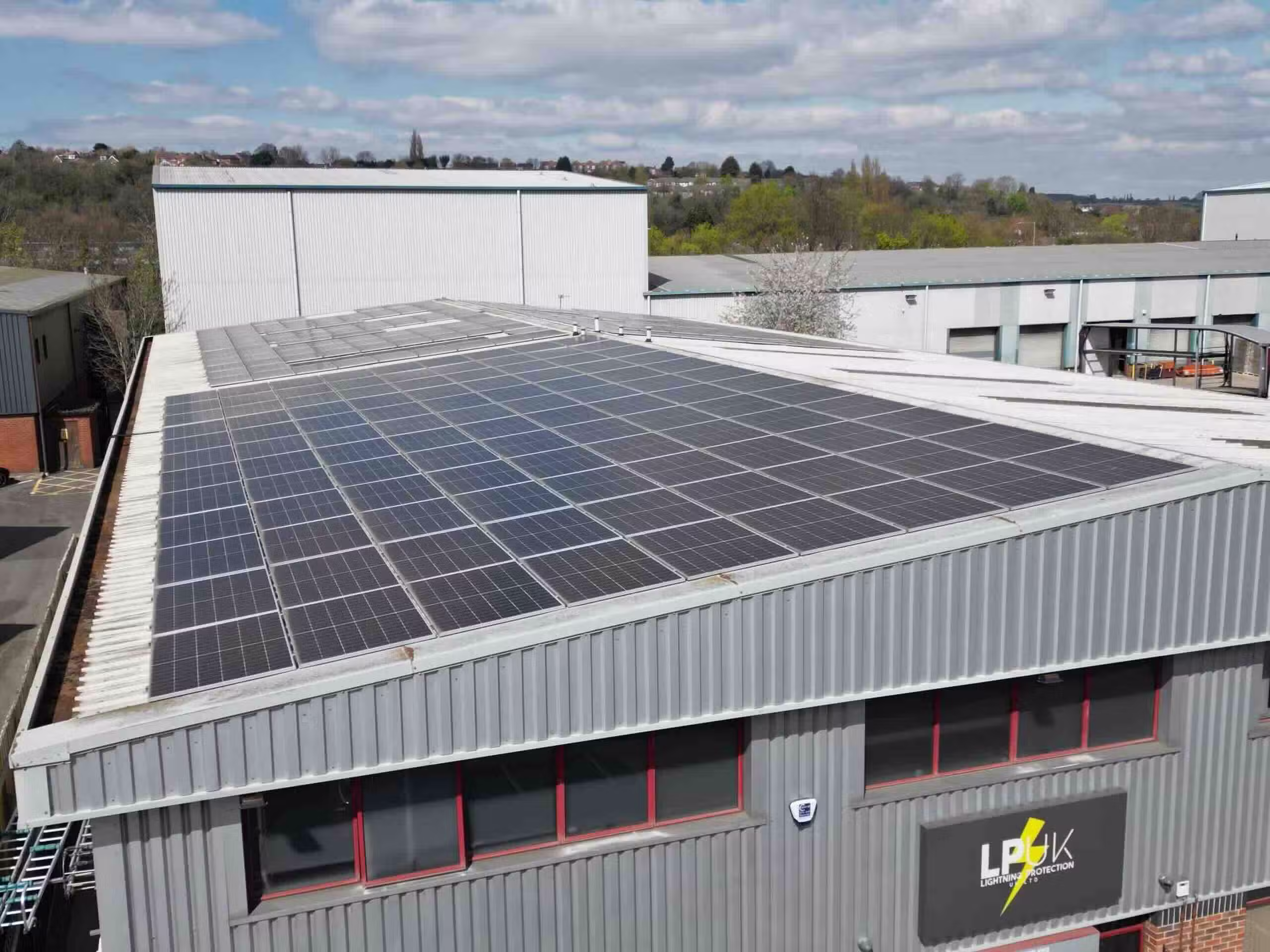 Large-scale commercial solar panel installation on an industrial roof in Carlton