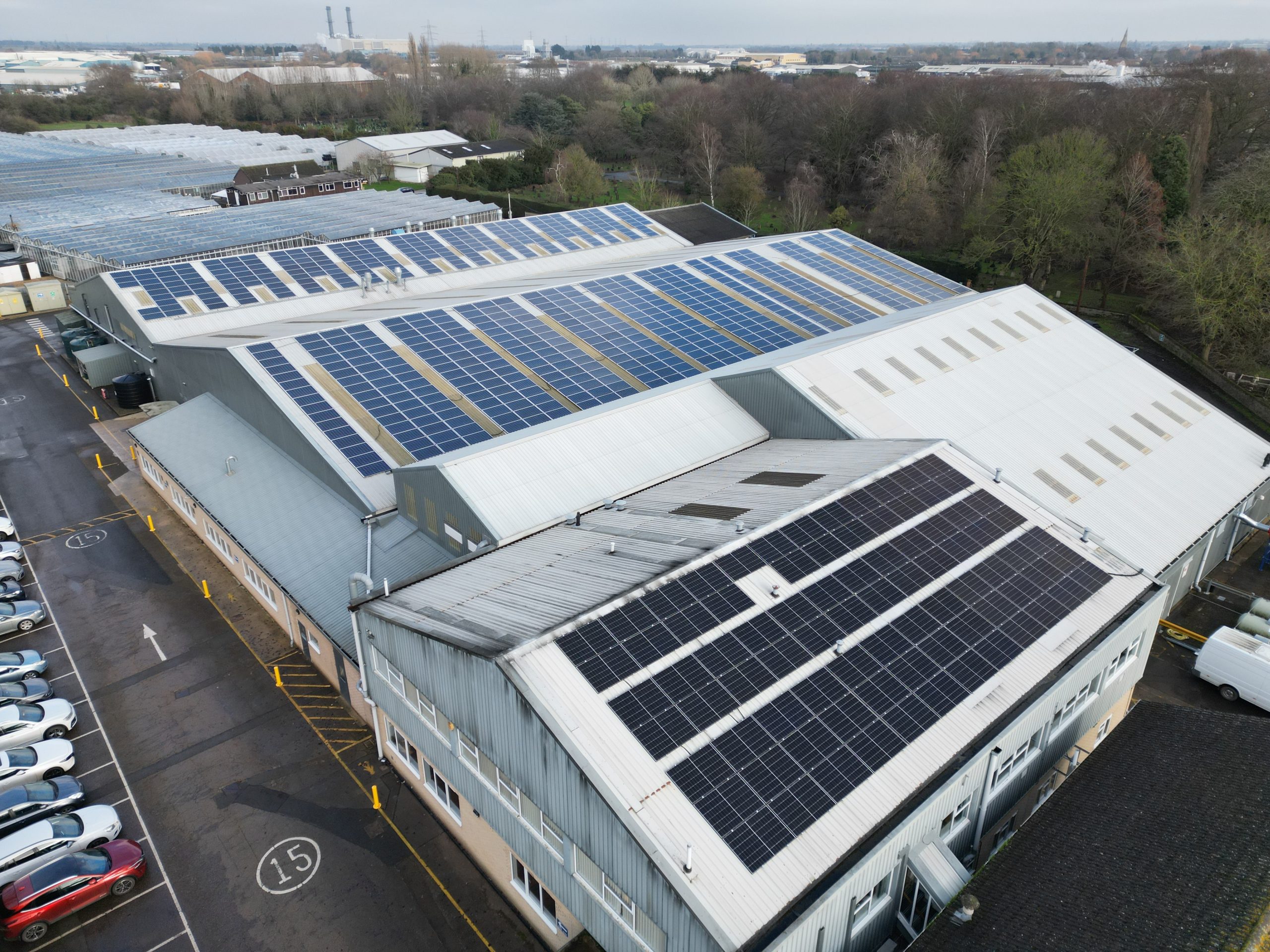 Aerial overview of 177kWp solar panel array installed on corrugated metal warehouse roof at Elsoms Seeds