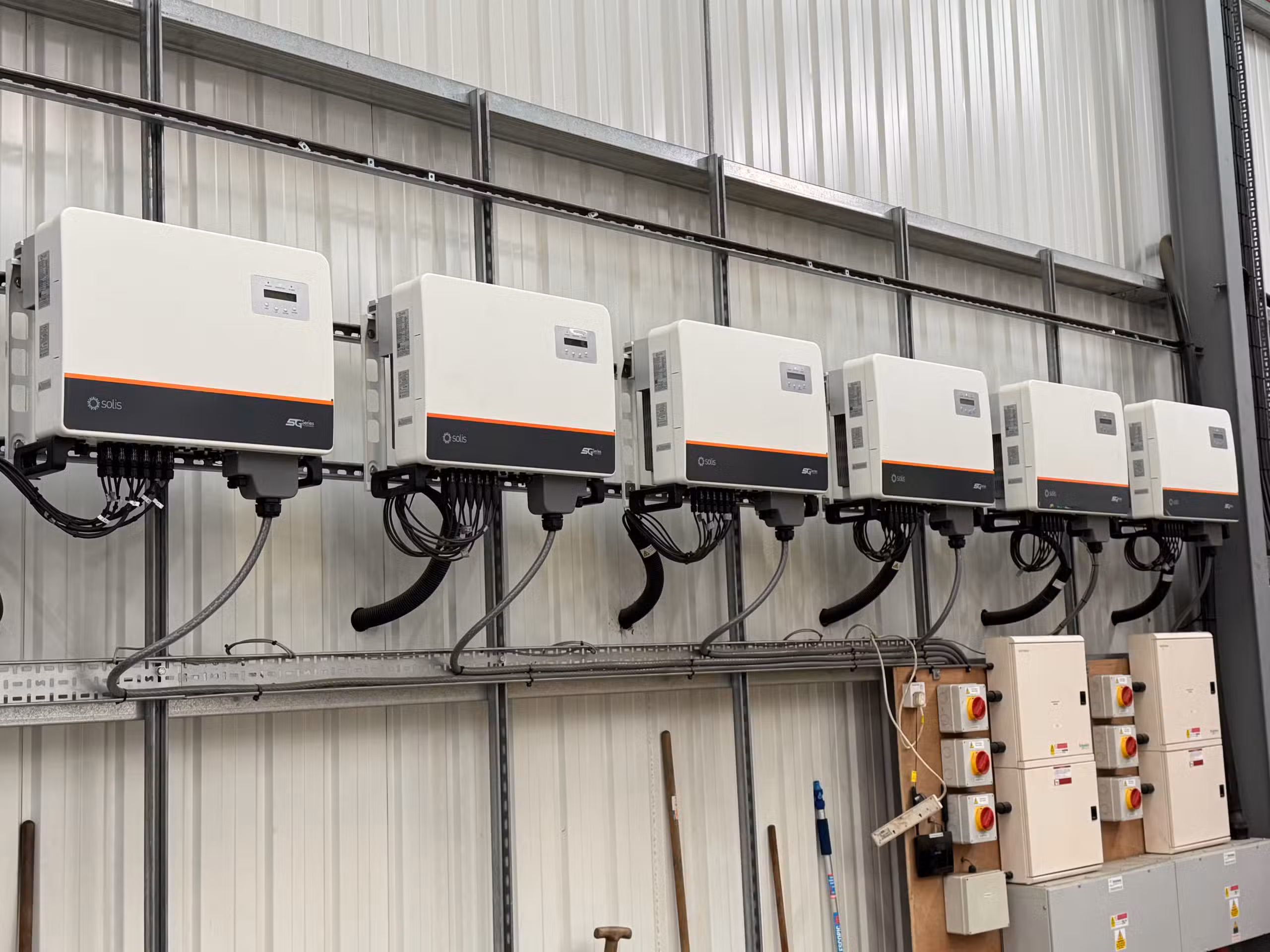 Six Solis 25kW string inverters wall-mounted in plant room as part of commercial solar inverter replacement at Elsoms Seeds, Spalding
