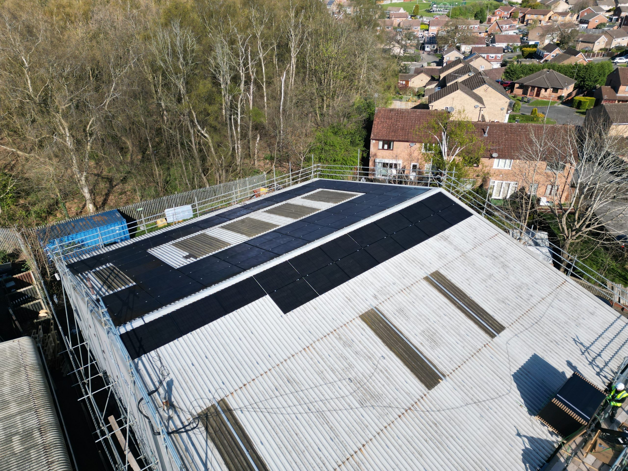 Progress overview of 67kW JA Solar panel array on portal frame metal roof at Linear Insulation, Nottingham