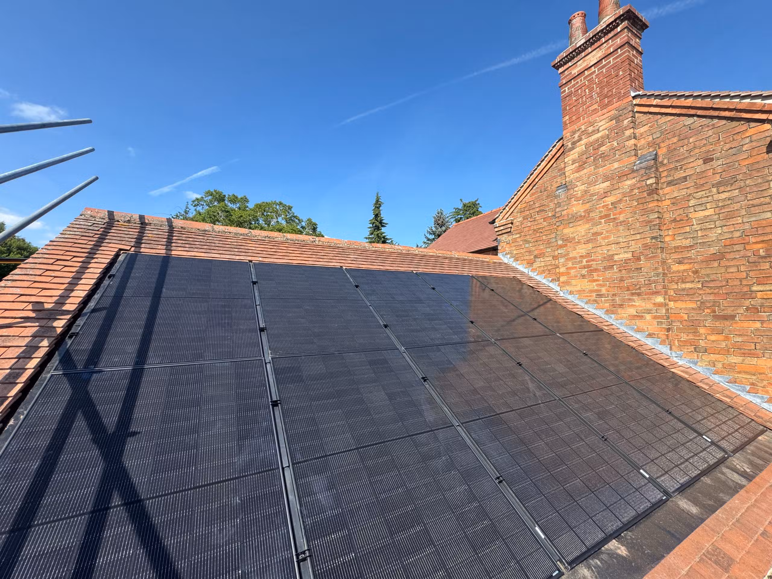 DMEGC 450W all-black solar panels in GSE in-roof mounting system on garage roof at Woodborough