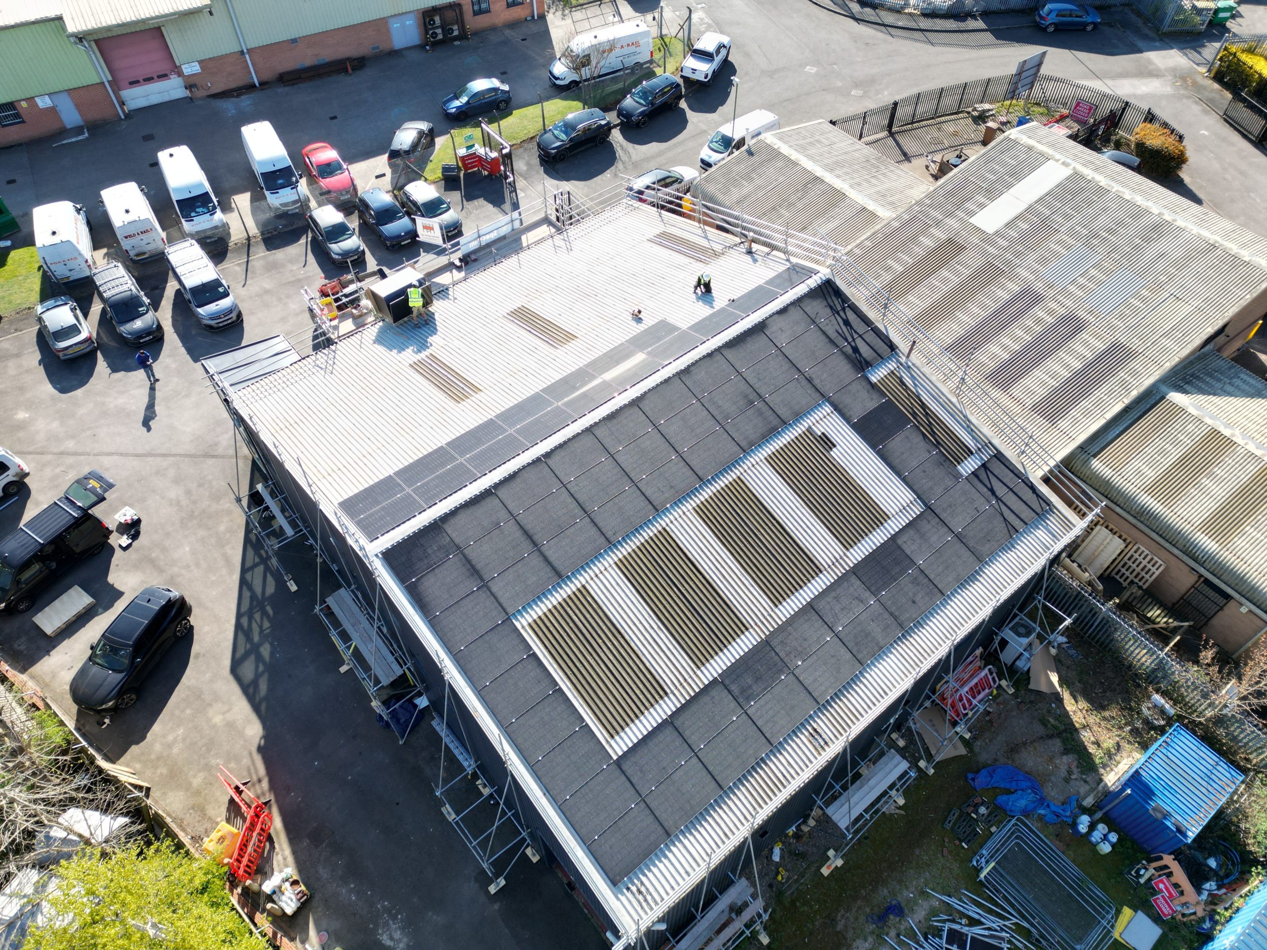 Aerial overview of JA 455W solar panels on metal sheet roof during installation at Linear Insulation