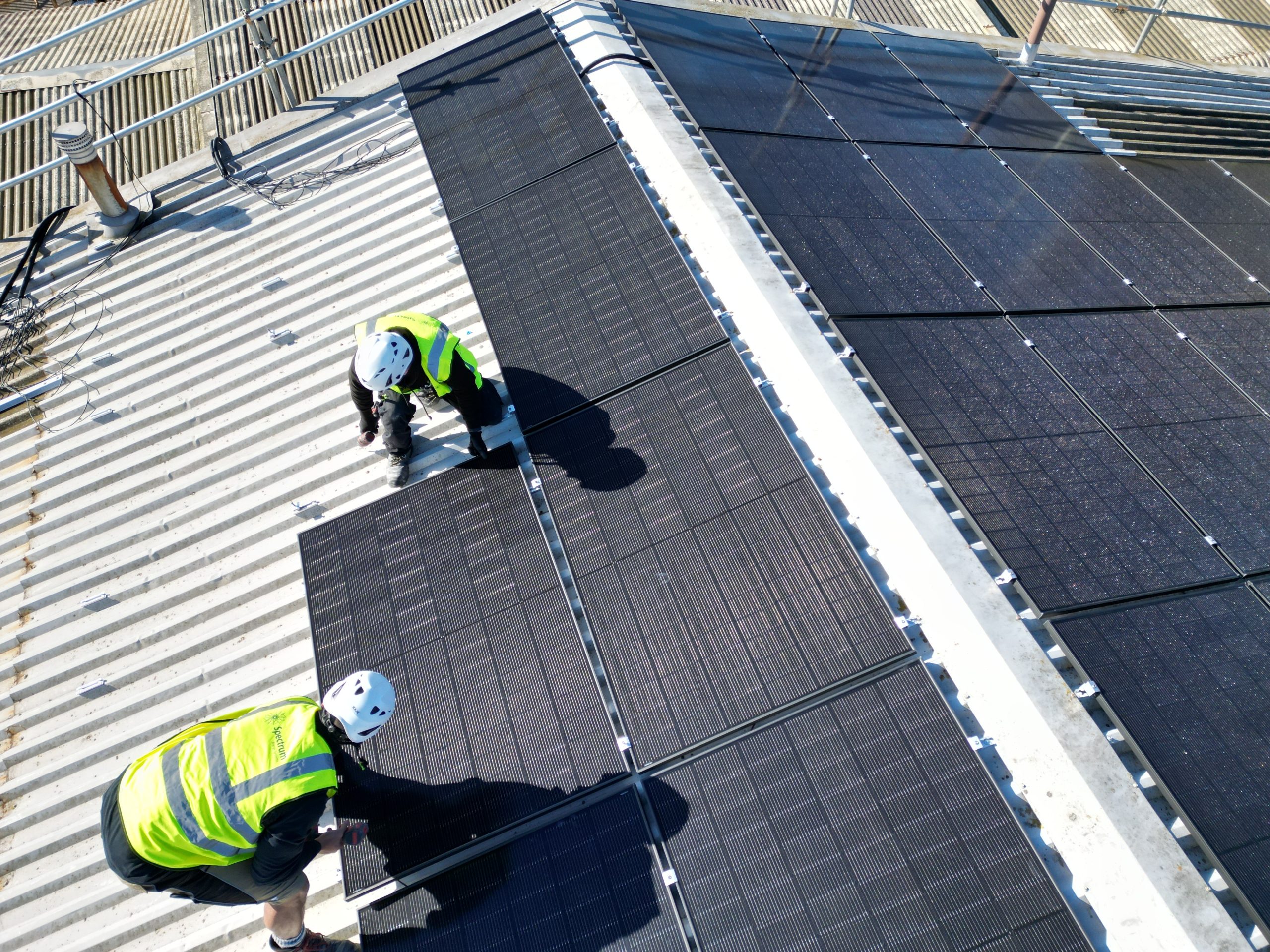 Detail view of JA Solar 455W panels installed on corrugated metal roof at Linear Insulation, Lockwood Close