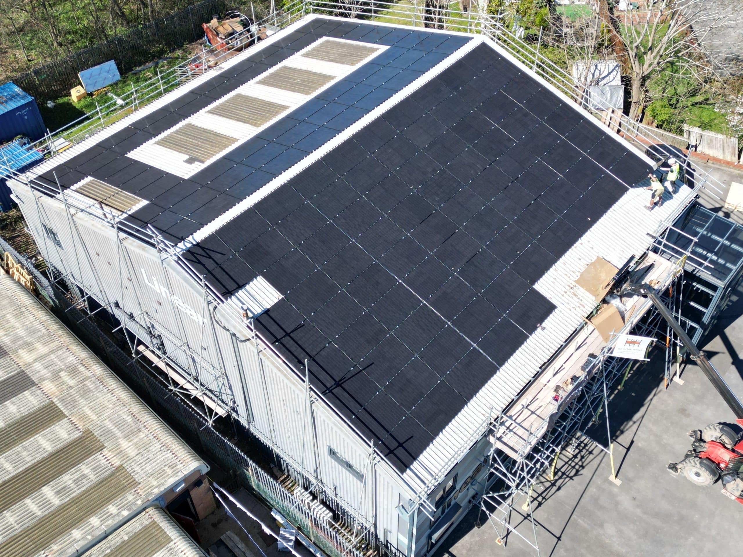 Aerial view of JA Solar 455W panels being installed on large commercial roof at Linear Insulation