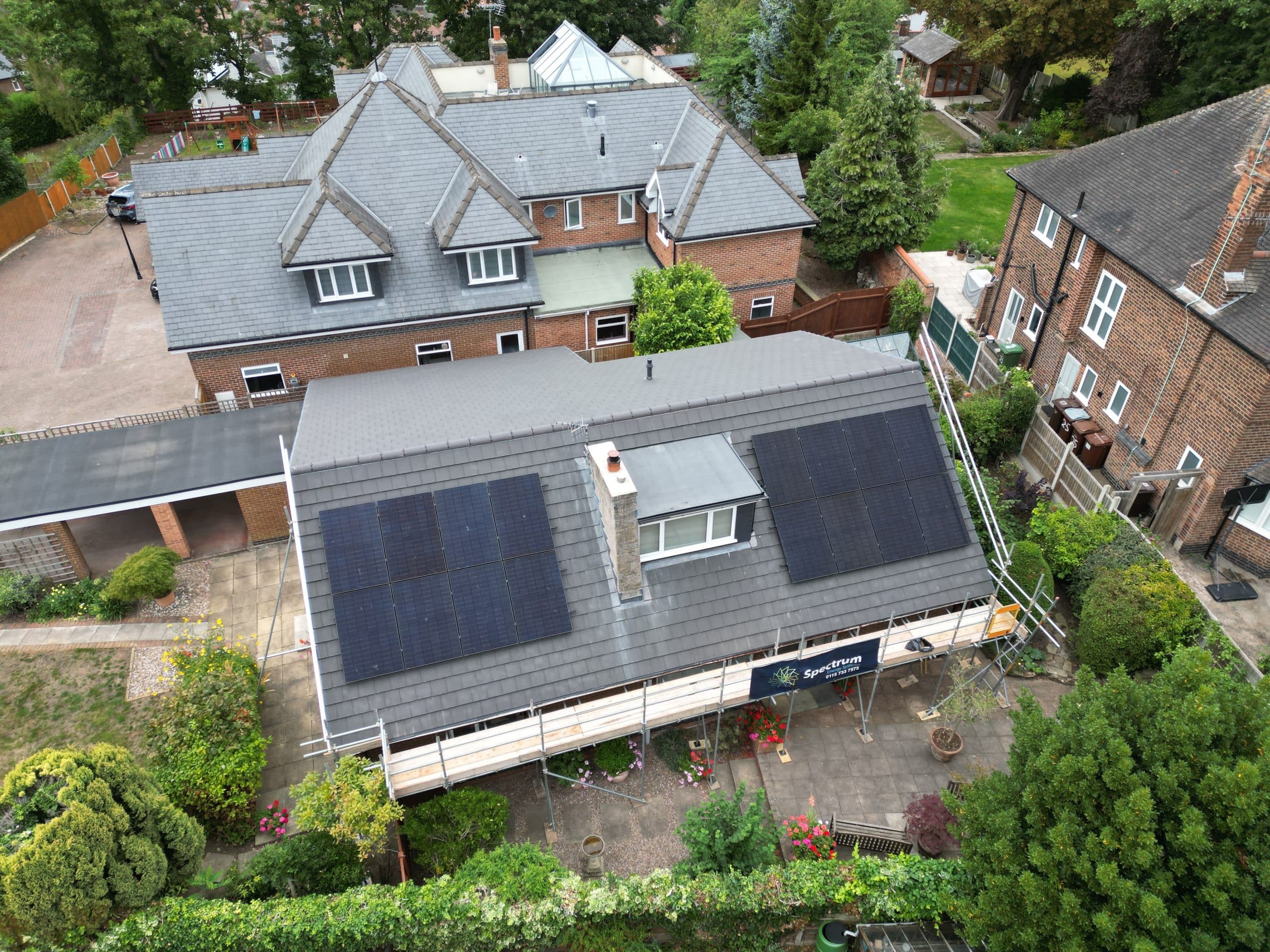 Drone view of JA Solar all-black panel installation with scaffolding at Sherwood home