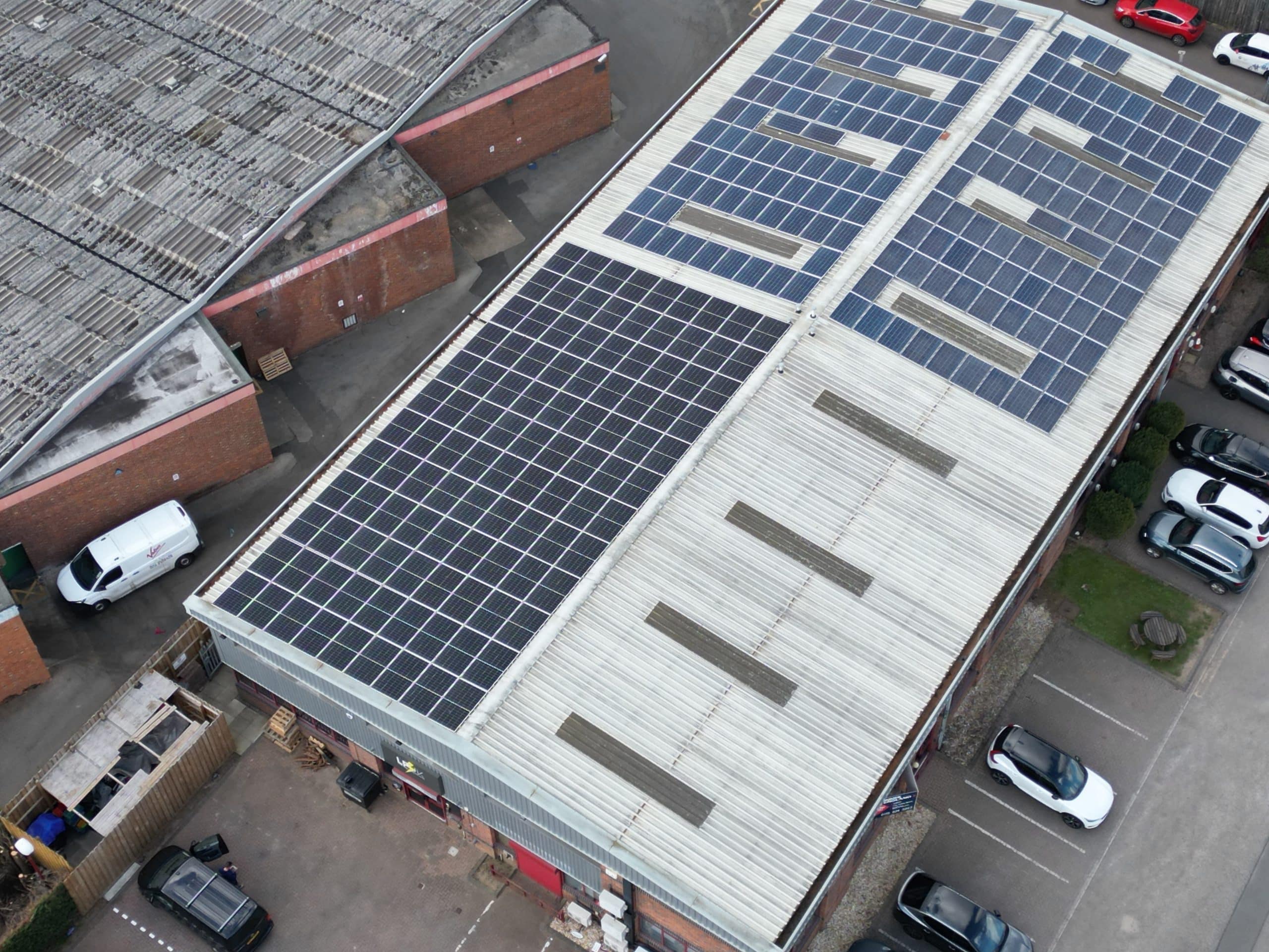 Flat roof solar panels tilted south-facing commercial building UK