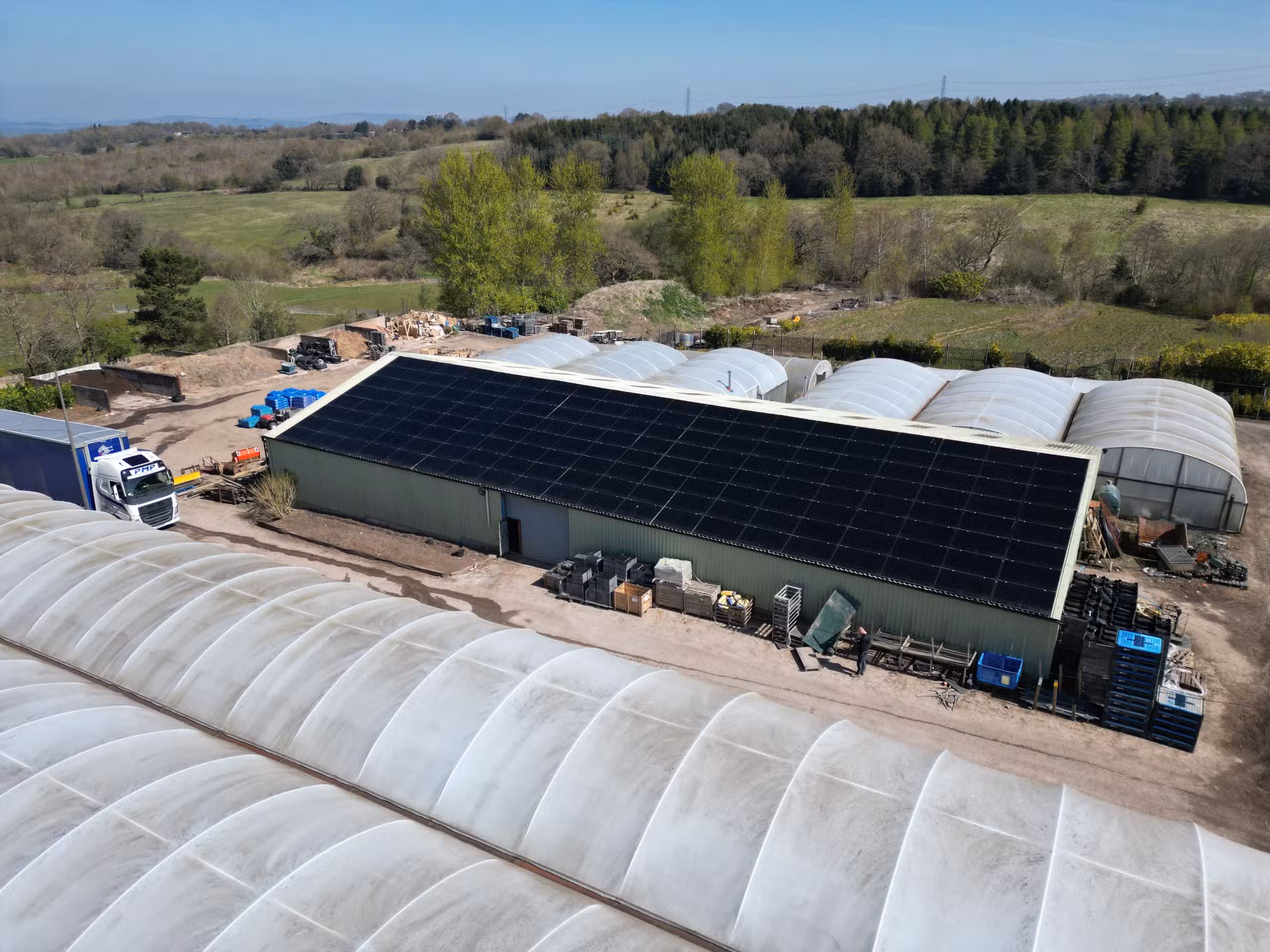 Portable solar panels set up beside a campervan generating off-grid power during a camping trip