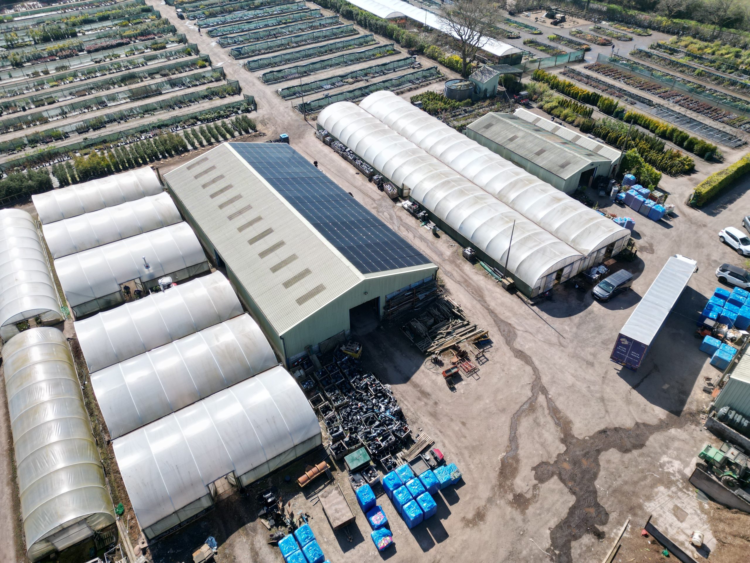 56kW Aiko 455W solar panels aerial overview on trapezoidal metal roof at Jacksons Nurseries garden centre