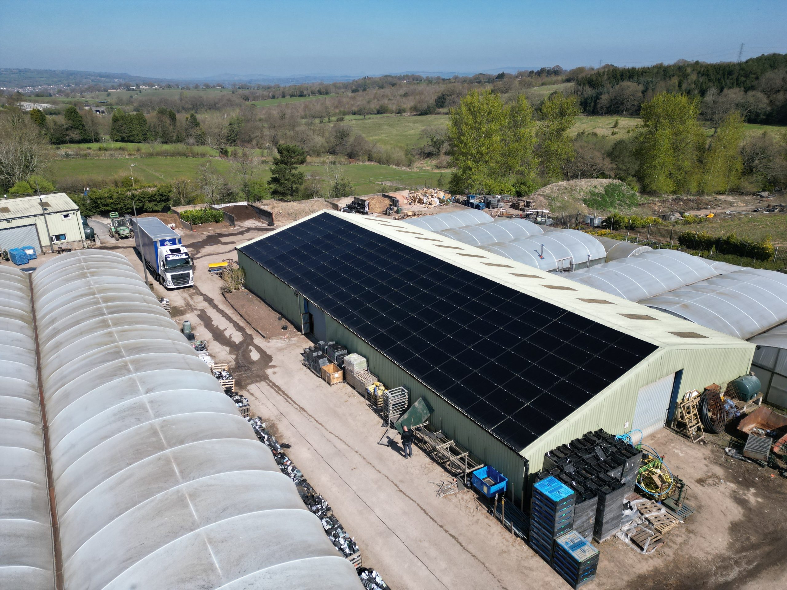 Rooftop solar panel array on trapezoidal metal roof at Jacksons Nurseries garden centre in Bagnall, Stoke on Trent