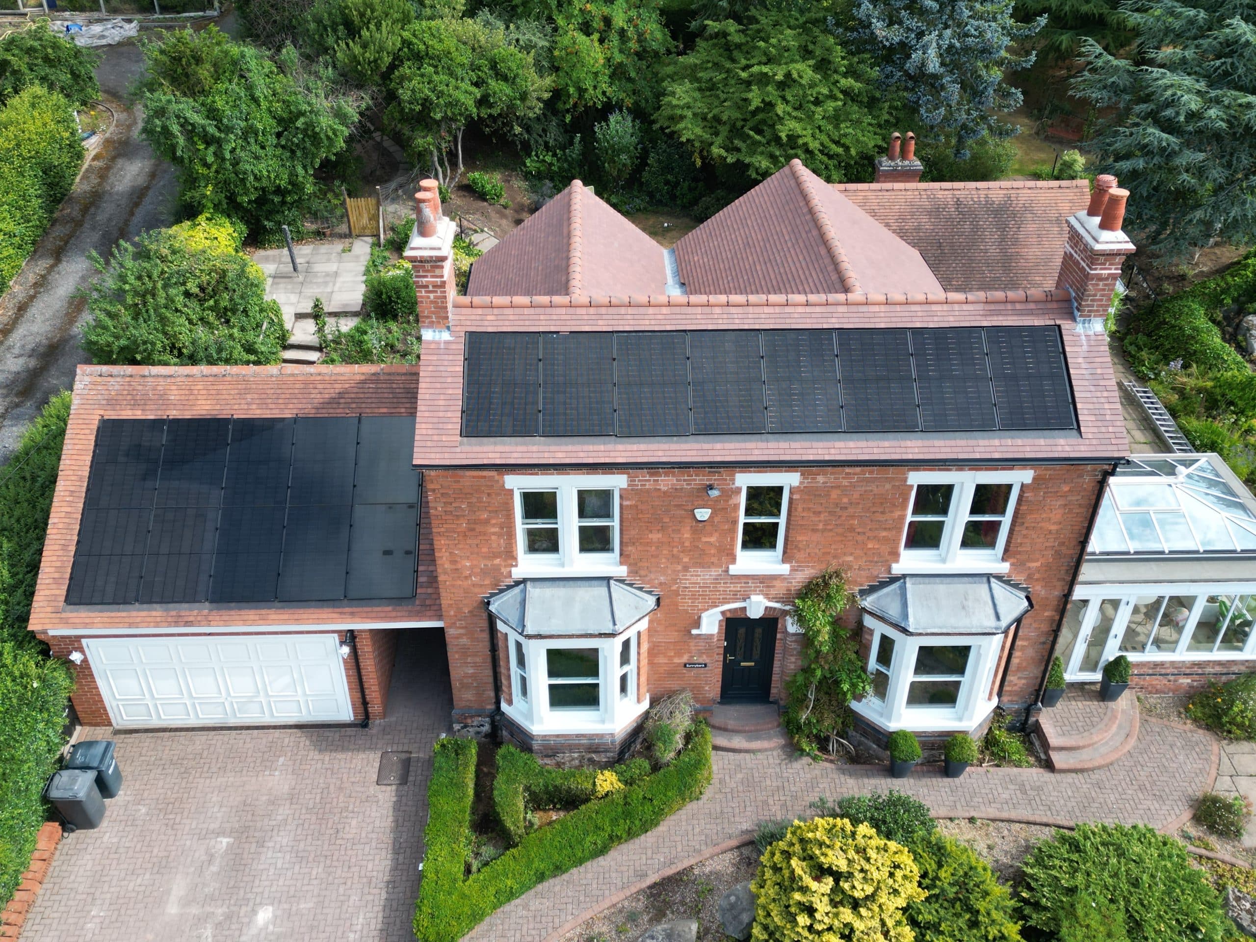 Do solar panels increase home value example, flush in-roof solar array on a period detached home and garage (Spectrum Energy Systems UK installation)