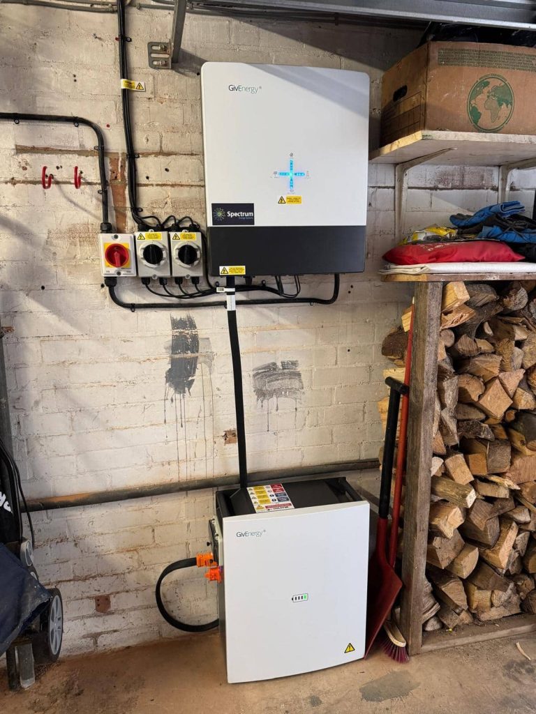 Solar battery and hybrid inverter neatly installed in a garage by Spectrum Energy Systems