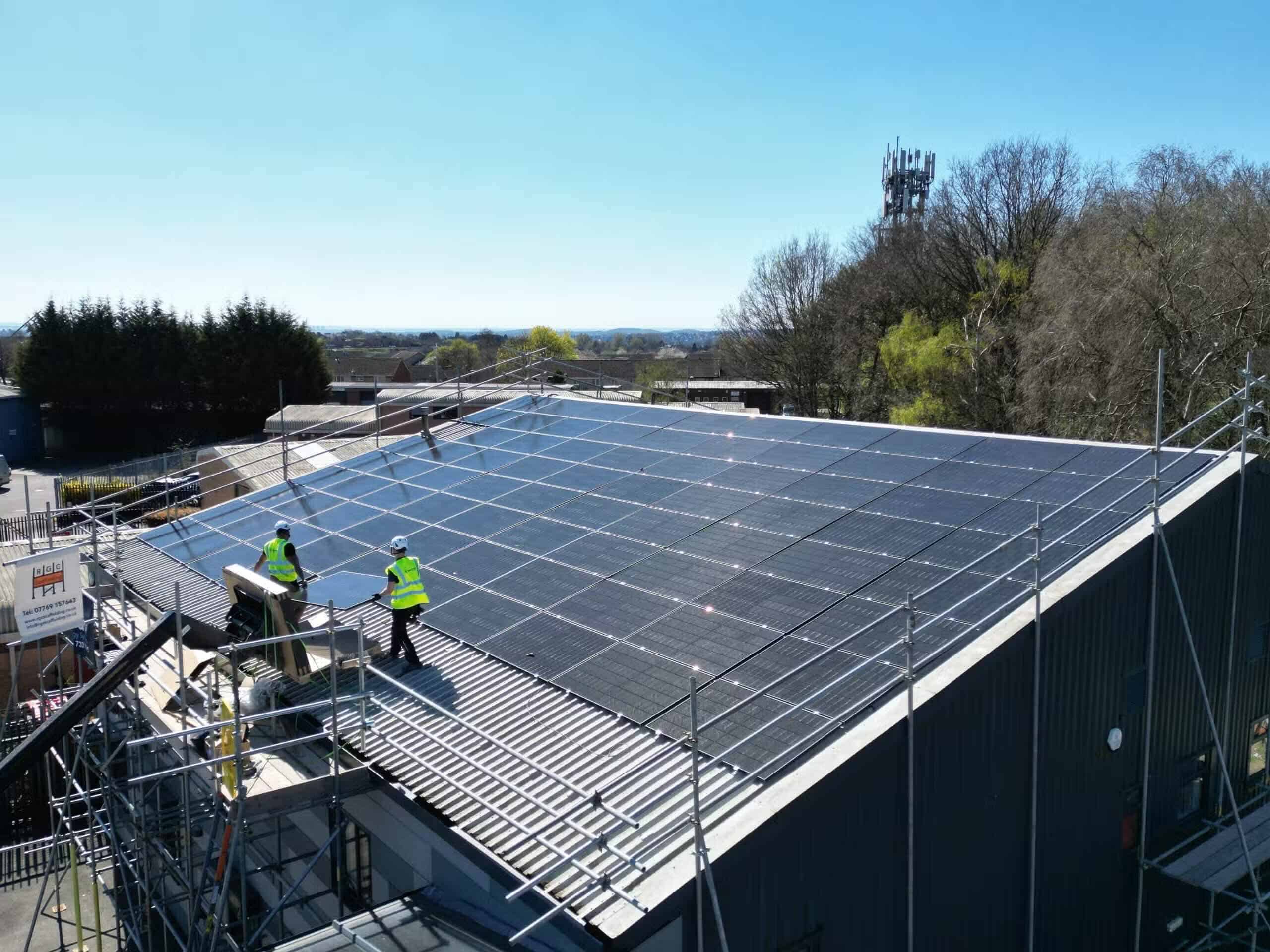 Solar panel installation cost Leicester guide, commercial rooftop solar install in progress with in-house crew (Spectrum Energy Systems UK installation)