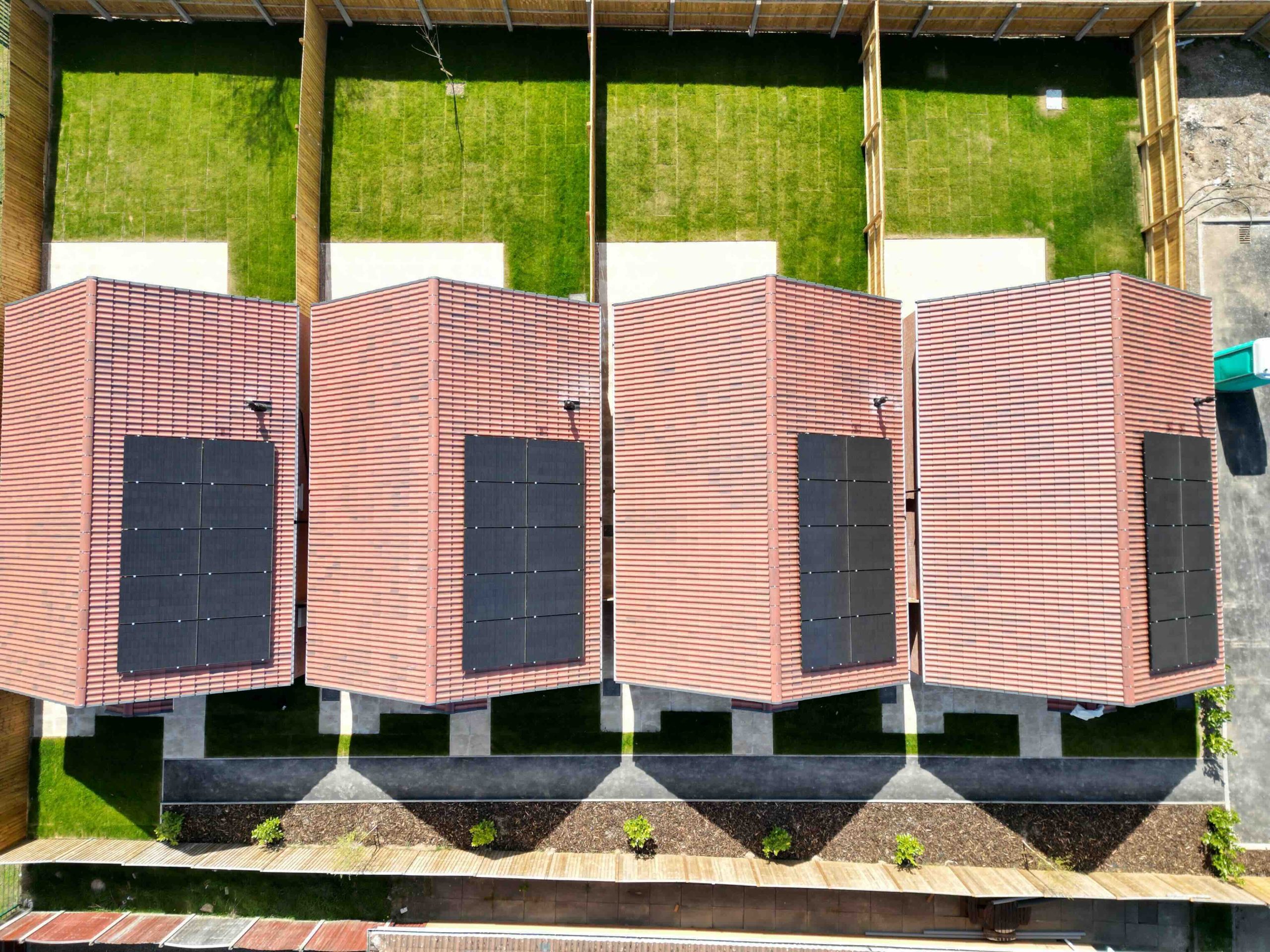 Solar panels for a 3 bed house cost example, panel arrays on a row of new build UK homes (Spectrum Energy Systems UK installation)