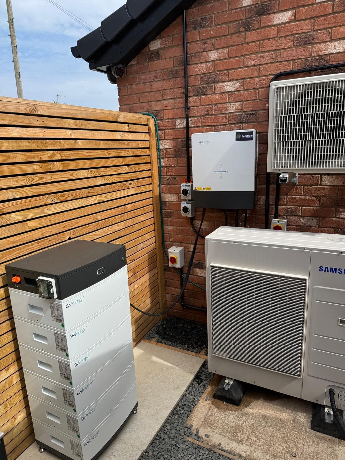 Solar panels power cut protection, home battery stack and hybrid inverter installed outside a UK home (Spectrum Energy Systems UK installation)