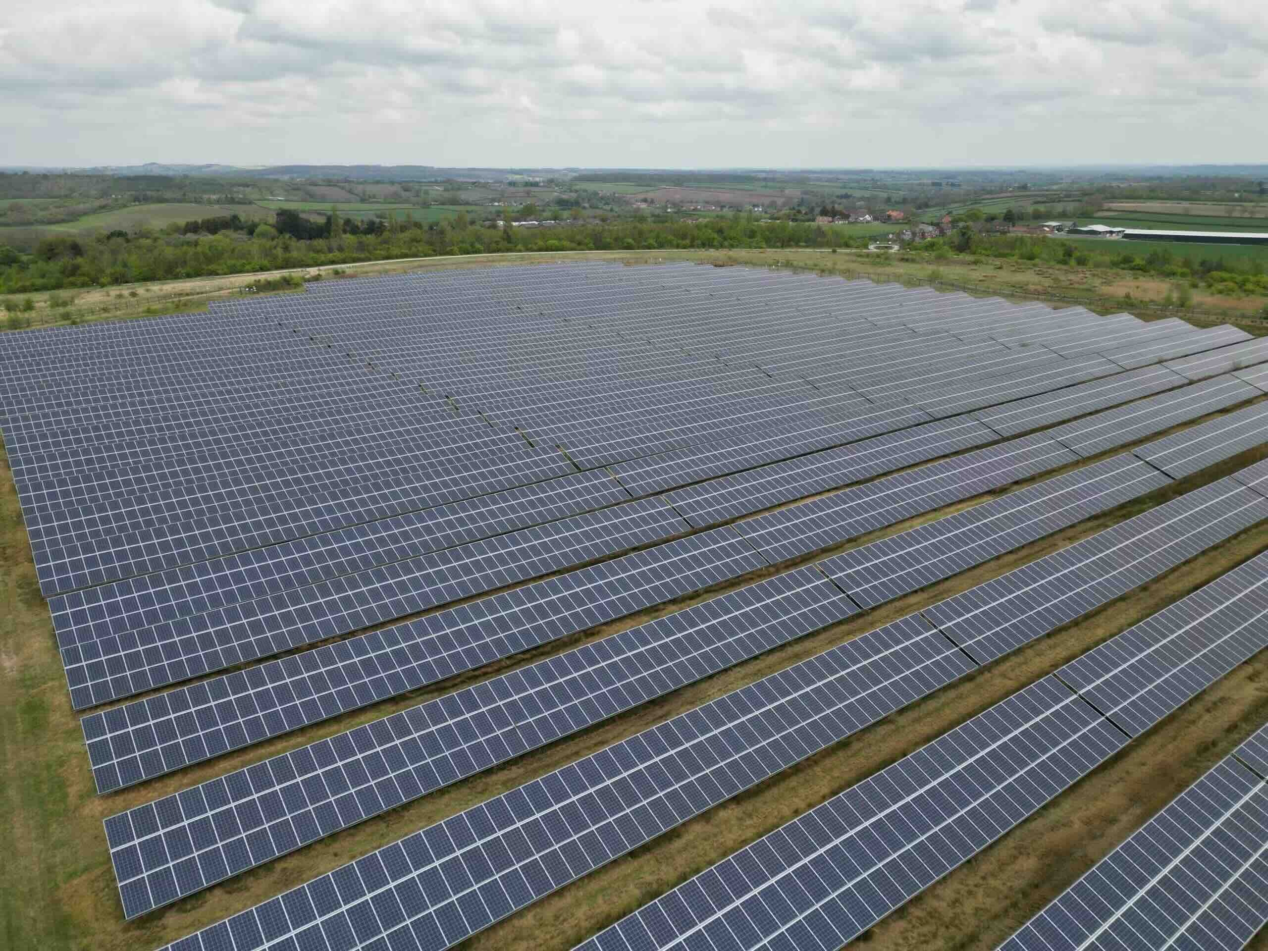 Rows of ground-mounted solar panels in a field, solar installers serving Chellaston