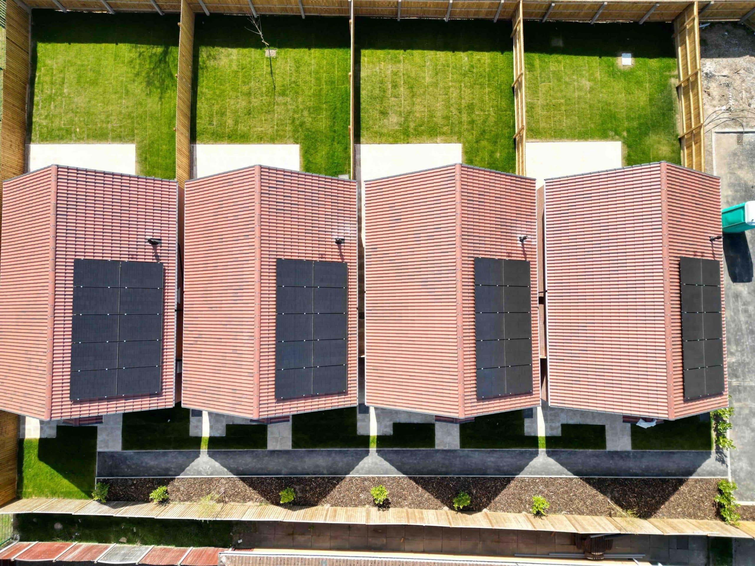 Aerial view of new-build homes each with rooftop solar panels, solar installers serving Chellaston