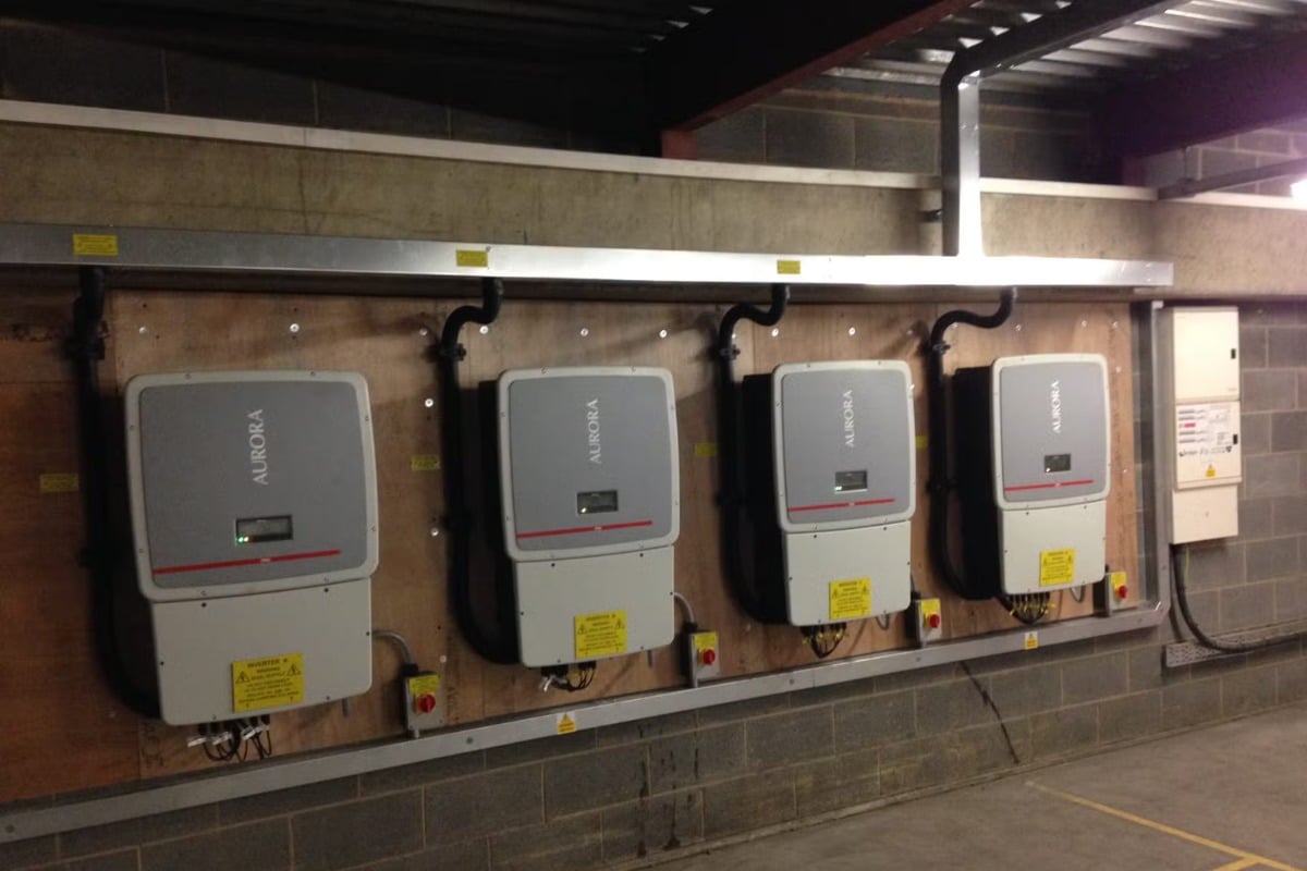 Solar inverters mounted on a plant room wall, solar installers serving Chellaston